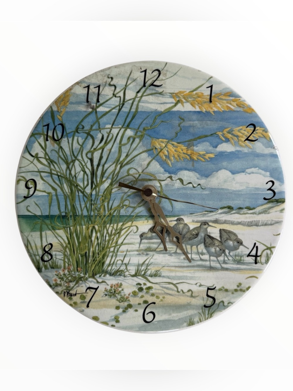 watercolor-style beach scene with shorebirds and dune grass ceramic clock